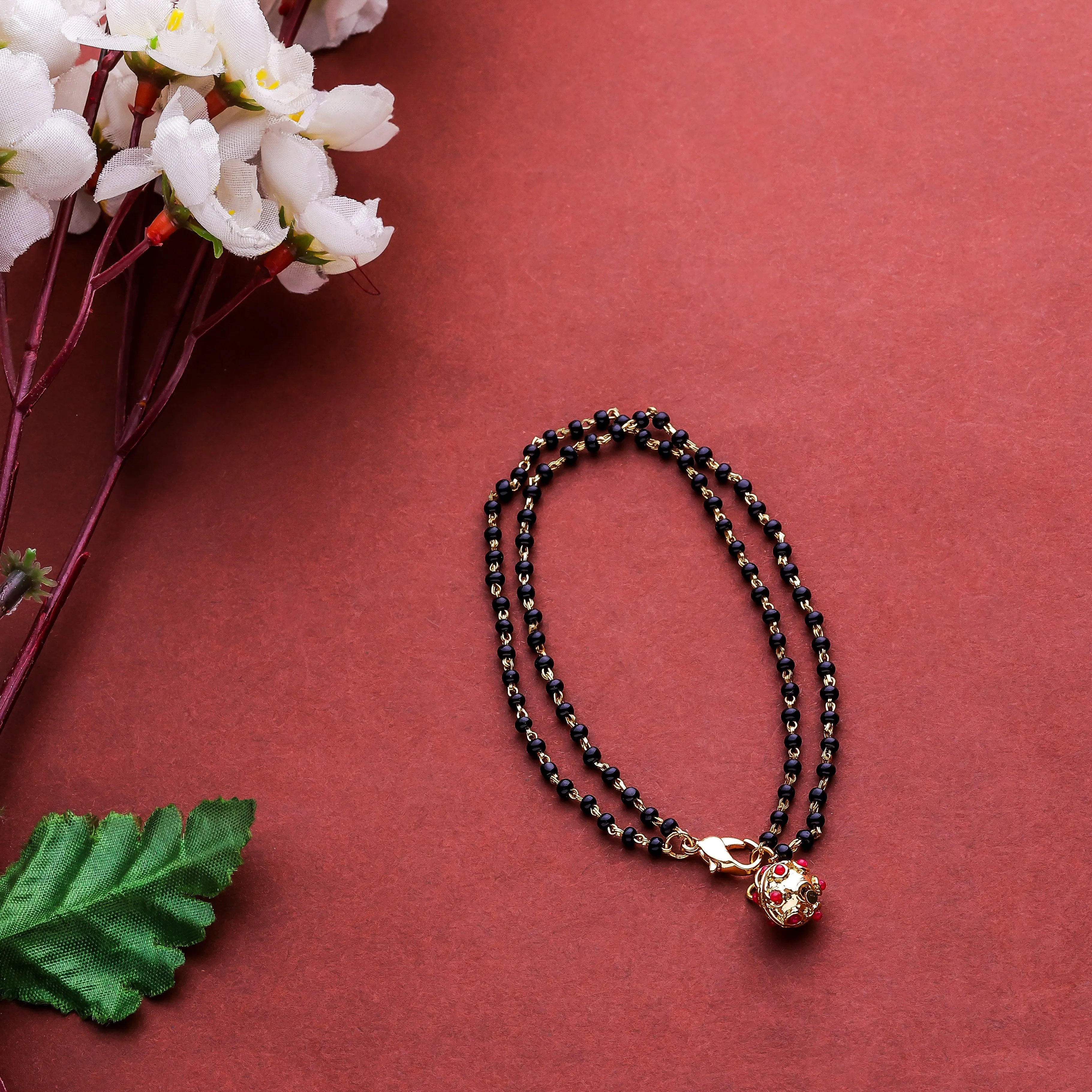 Estele Gold Plated Beautiful Black Beads Bracelet with Ruby Stones for Women